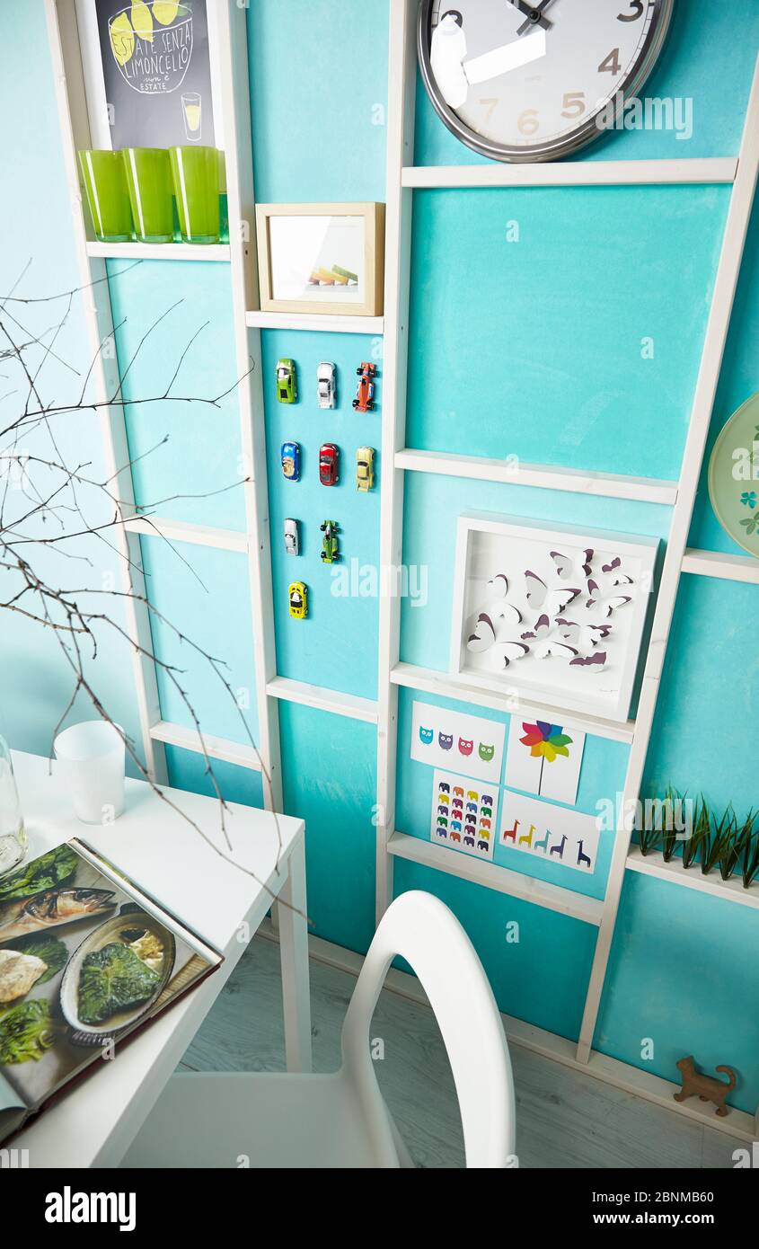 DIY wall design 02, step-by-step do-it-yourself production, various turquoise colored areas separated by white wooden strips, final photo 02 in the living room with decoration Stock Photo