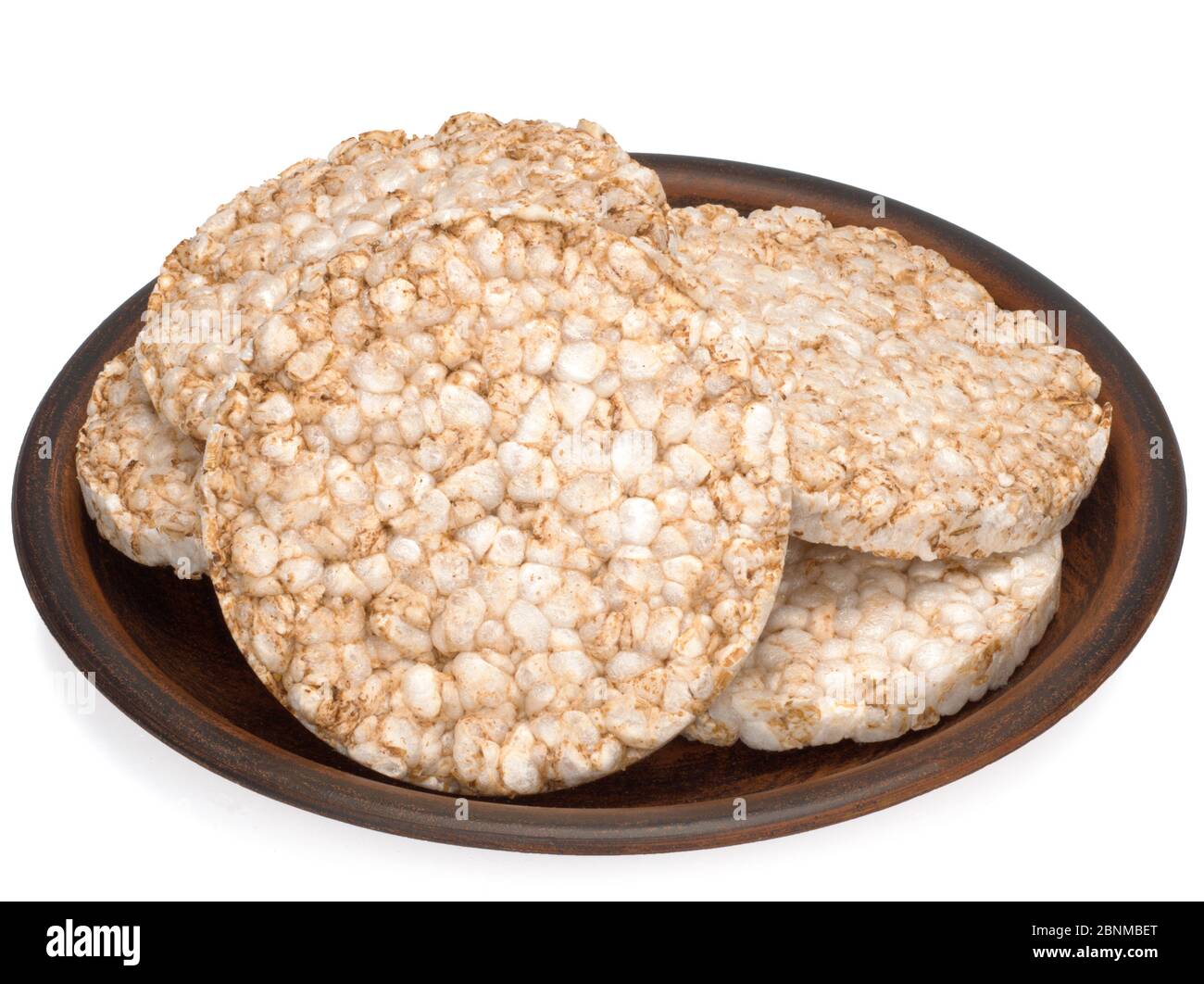Puffed rice bread in a plate isolated on white background, diet crispy ...