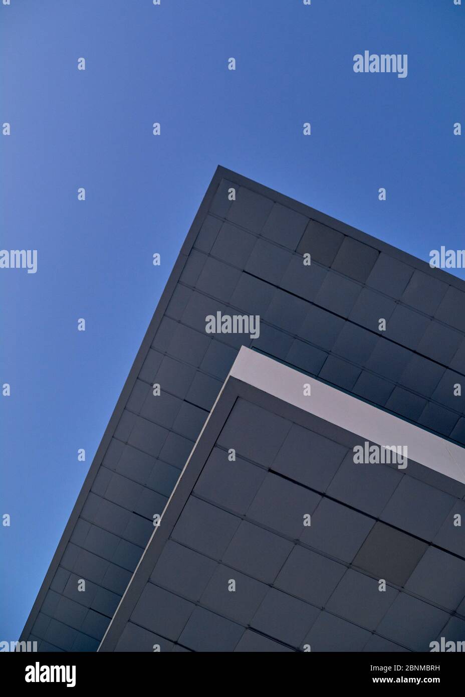 Modernist building roof in blue sky, parallel lines, symmetry, modernism, blue hour Stock Photo