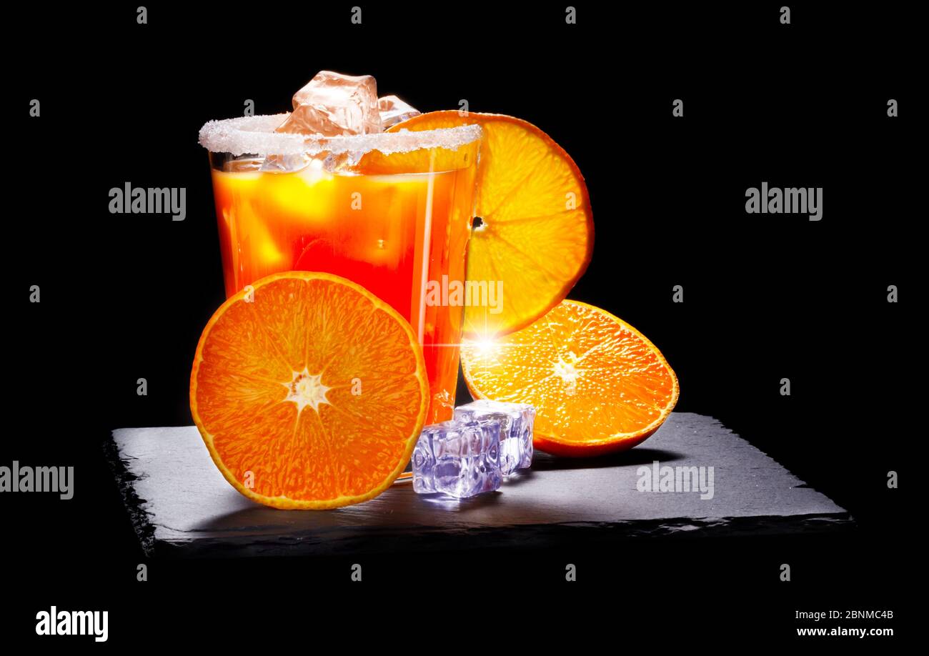 Orange juice, ice cubes, oranges, sugar, slate Stock Photo Alamy