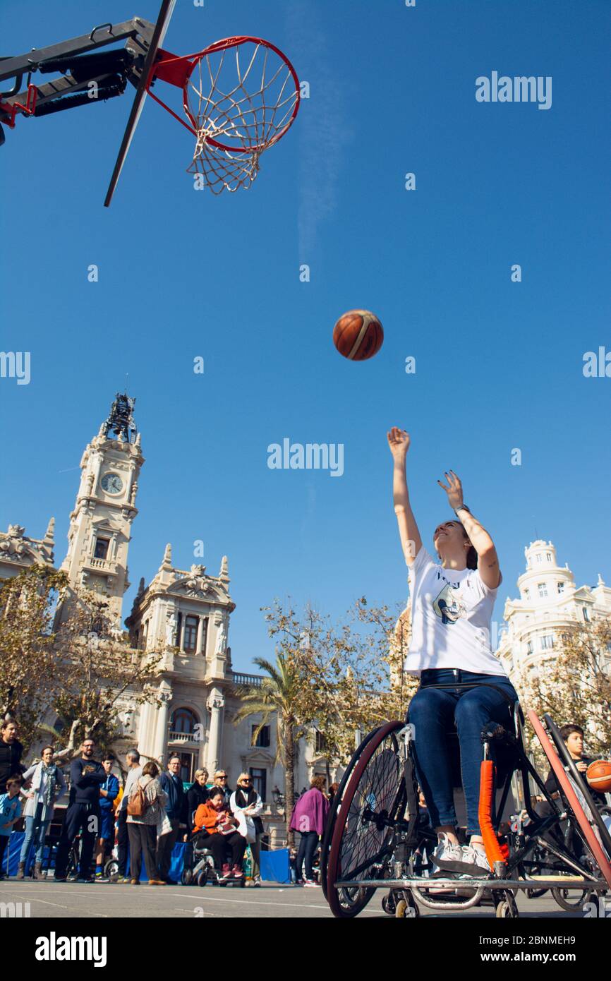 Valencia, Spain. February 15, 2020 - Adaptive sports day. An adaptive basketball player throwing the ball into the basket on the prepared court in the Stock Photo