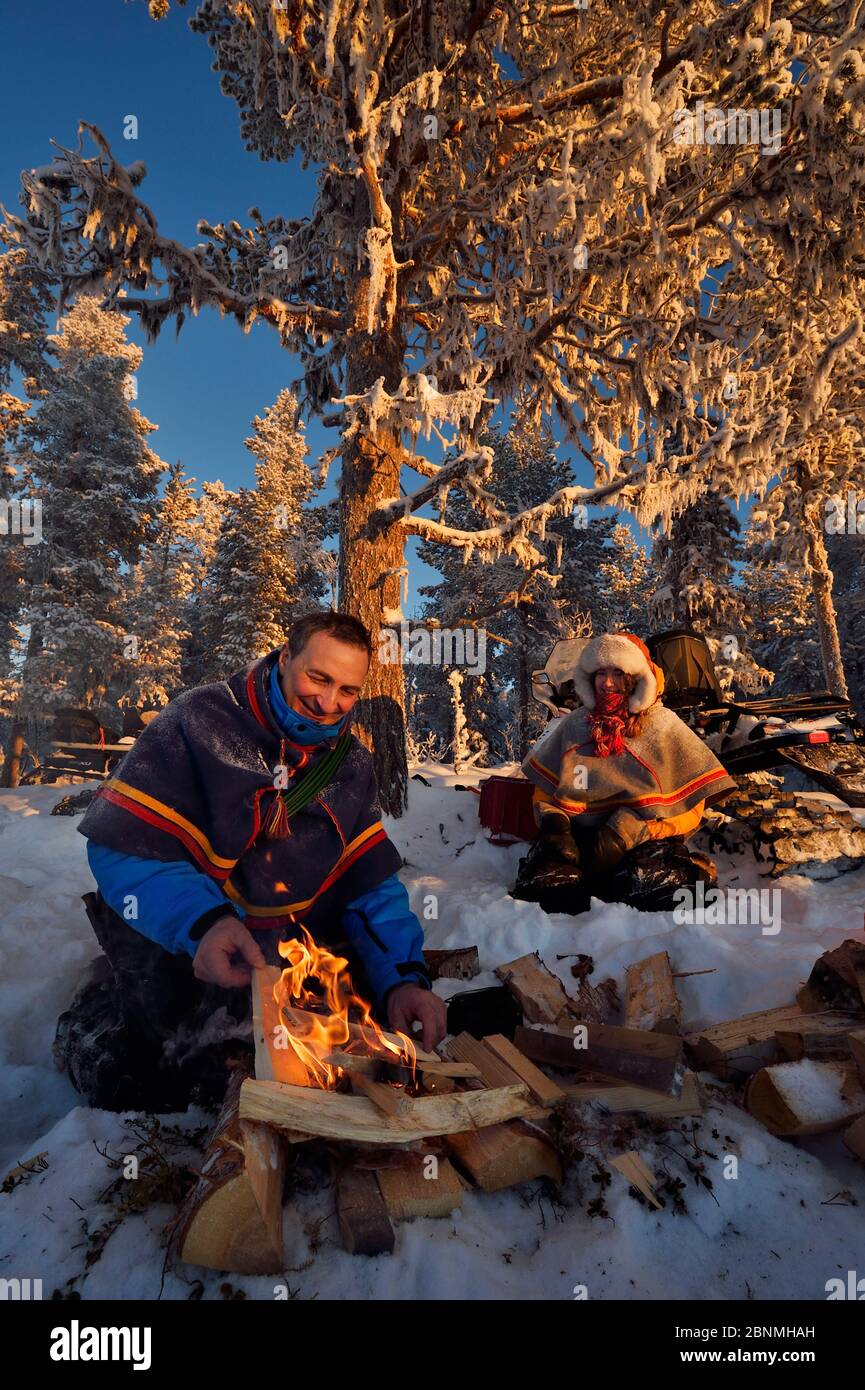 Nils-Torbjorn Nutti, owner and operator at Nutti Sami Siida, and Klara Enbom-Burreau on snowmobile trip into the wilderness, Jukkasjarvi, Lapland, Lap Stock Photo