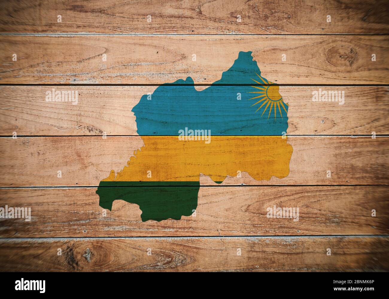 Map and flag of Rwanda on a wooden background. Stock Photo