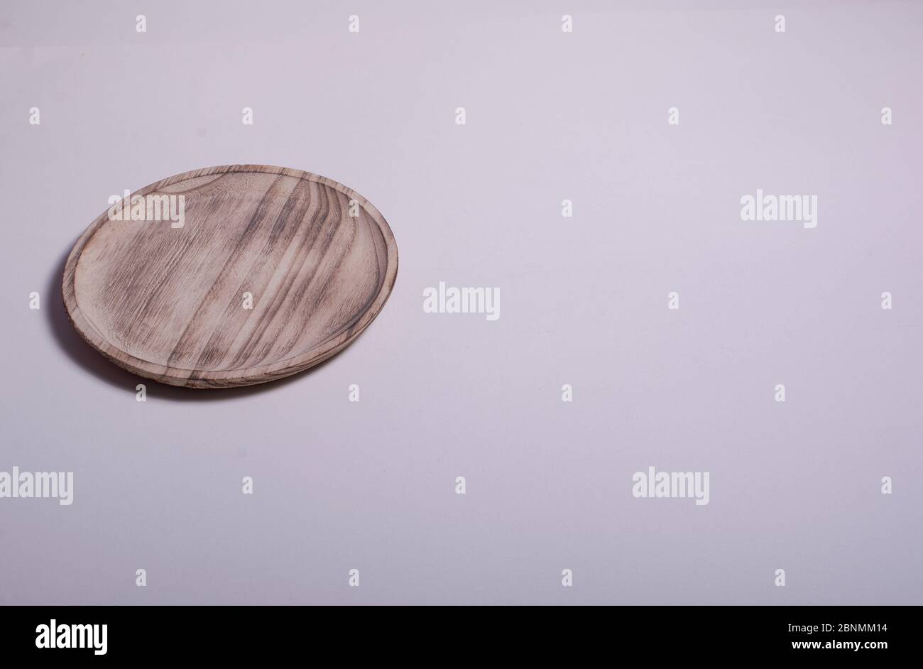 Old wooden plate on white background. Colors of nature Stock Photo - Alamy