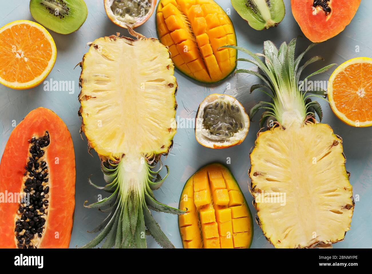 Halves of tropical fruits papaya, mango, pineapple, kiwi, orange and
