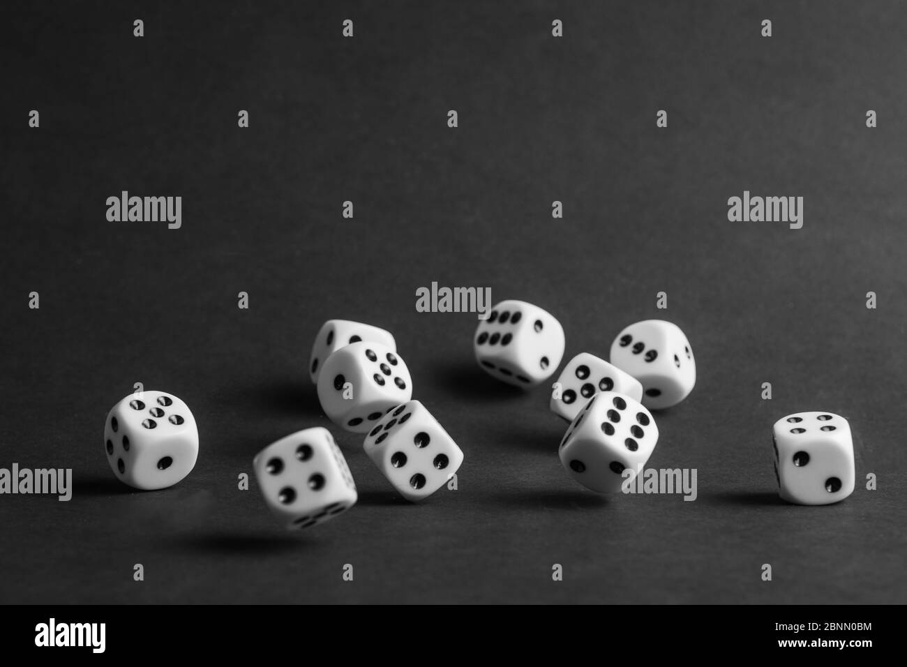 various tumbling dice on a black background in landscape format Stock Photo