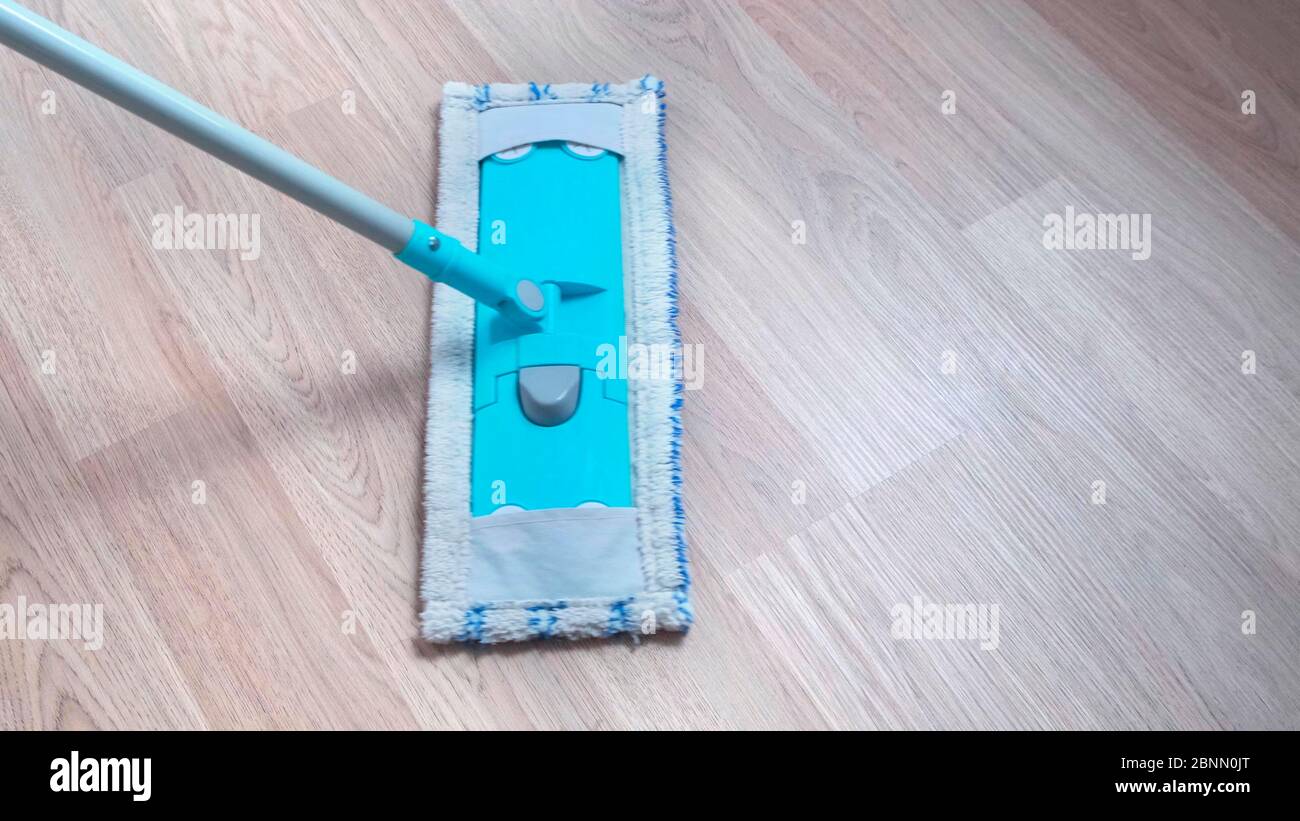 Wooden floor laminate cleaning with wet mop at home Stock Photo Alamy