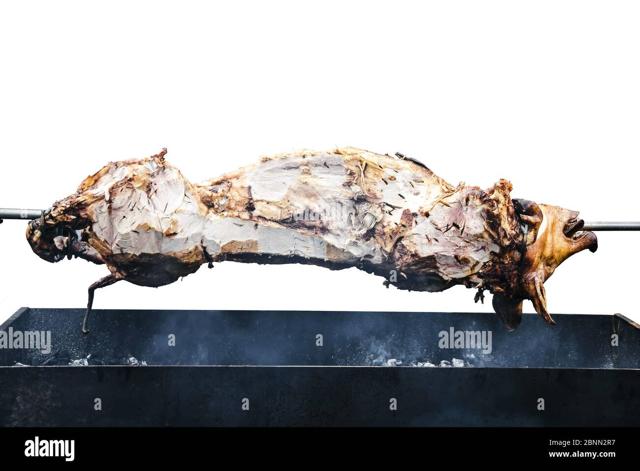 isolated grilled pig on the spit cooked on the grill, barbecue concept Stock Photo