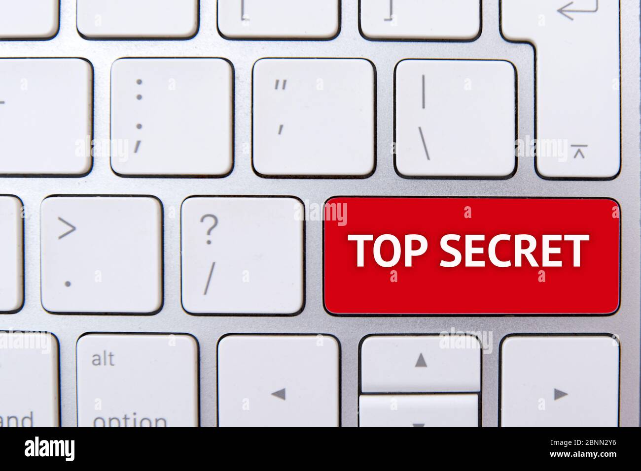 TOP SECRET text on red button of white keyboard, concept picture Stock Photo