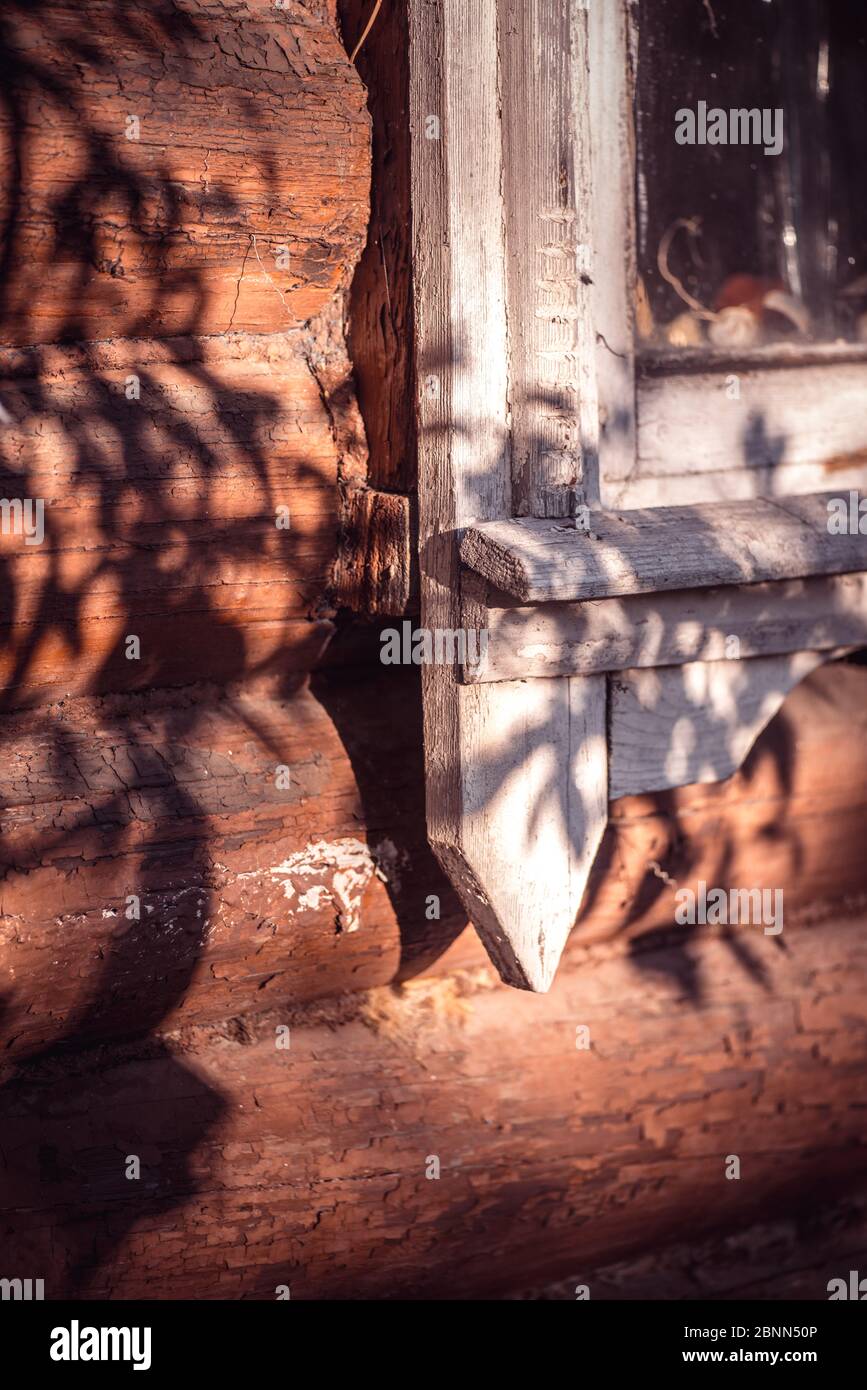 Old white painted wooden window with peeling paint from time to time on ...