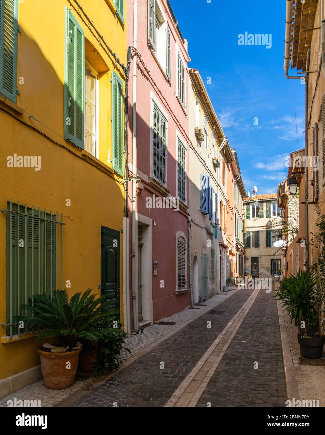 A pedestrian alleyway with colorful houses in the picturesque resort town of Cassis in  Southern France Stock Photo