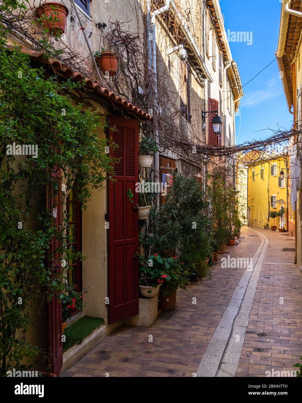 A colorful narrow street in the picturesque resort town of Cassis in  Southern France Stock Photo