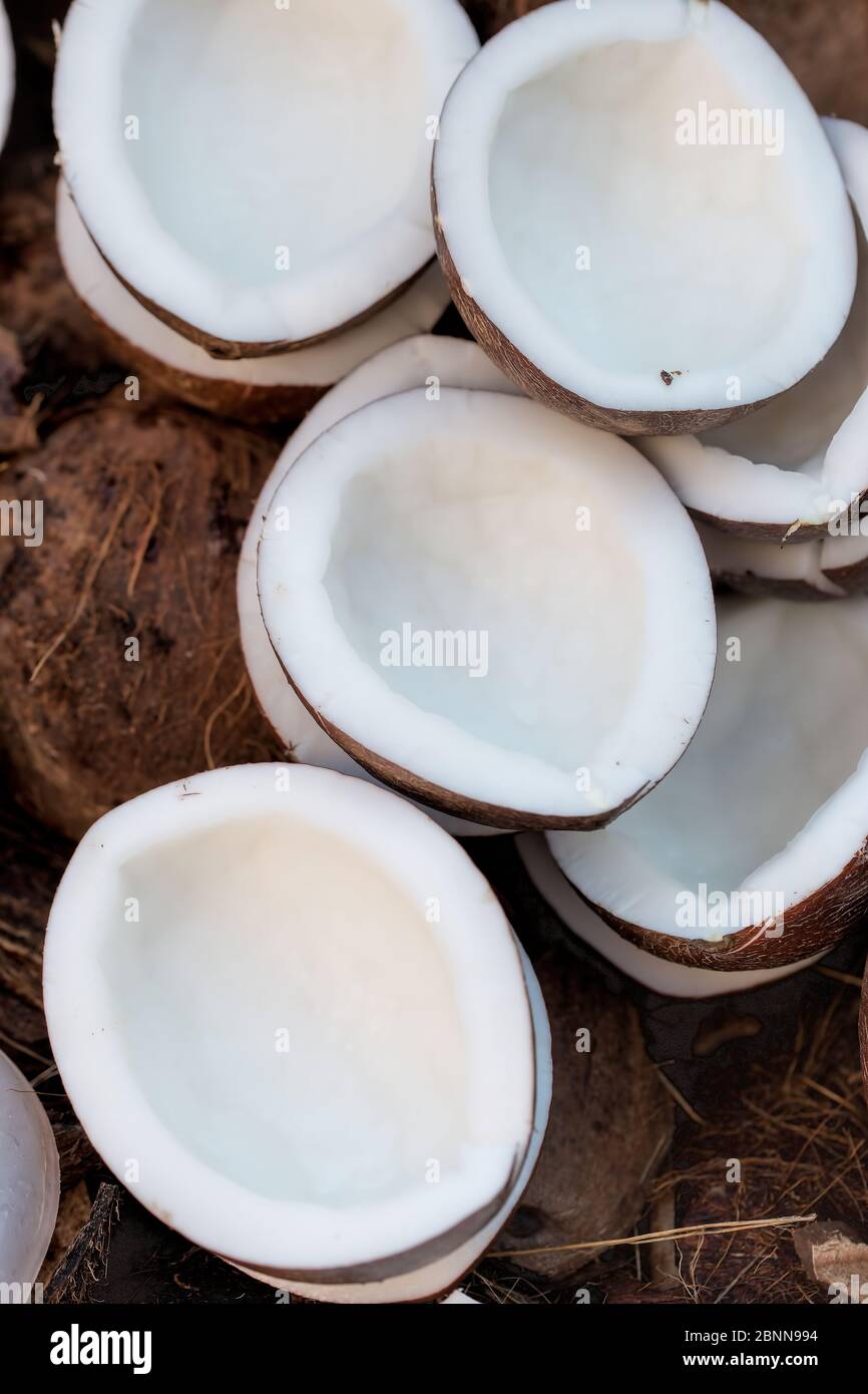 Coconut in shell halved halves, Morocco Stock Photo