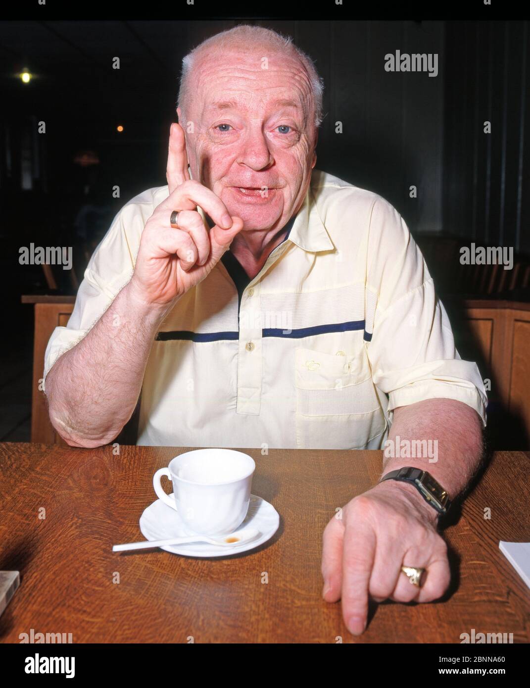 The popular Leipzig actor, cabaret artist and radio presenter Manfred Uhlig, also a loyal supporter of BSG Chemie Leipzig, moderates humorously in a Leipzig radio studio Stock Photo