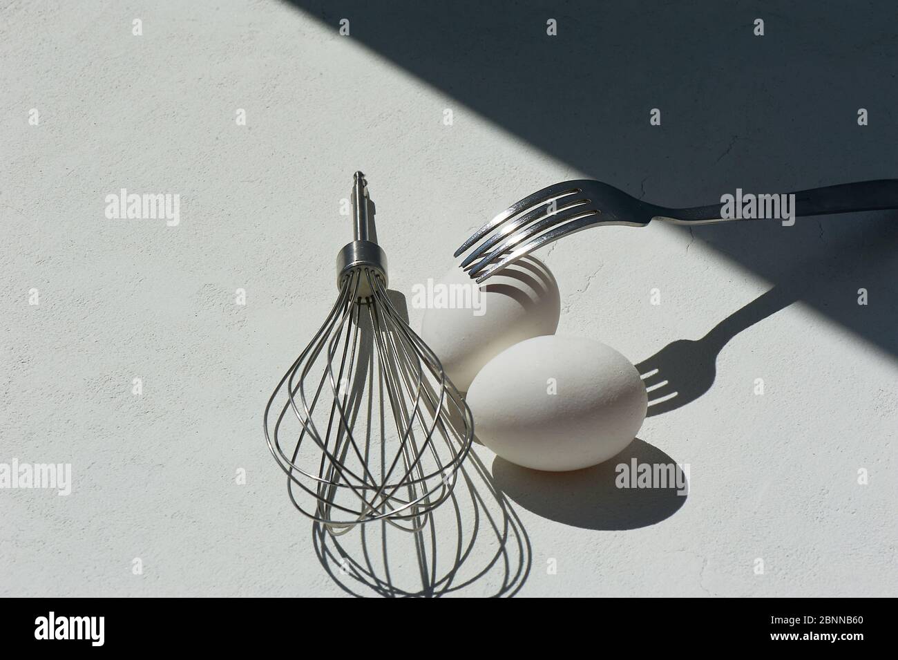 Egg with shadow from the fork. Minimalism. Cooking pastries, omelets