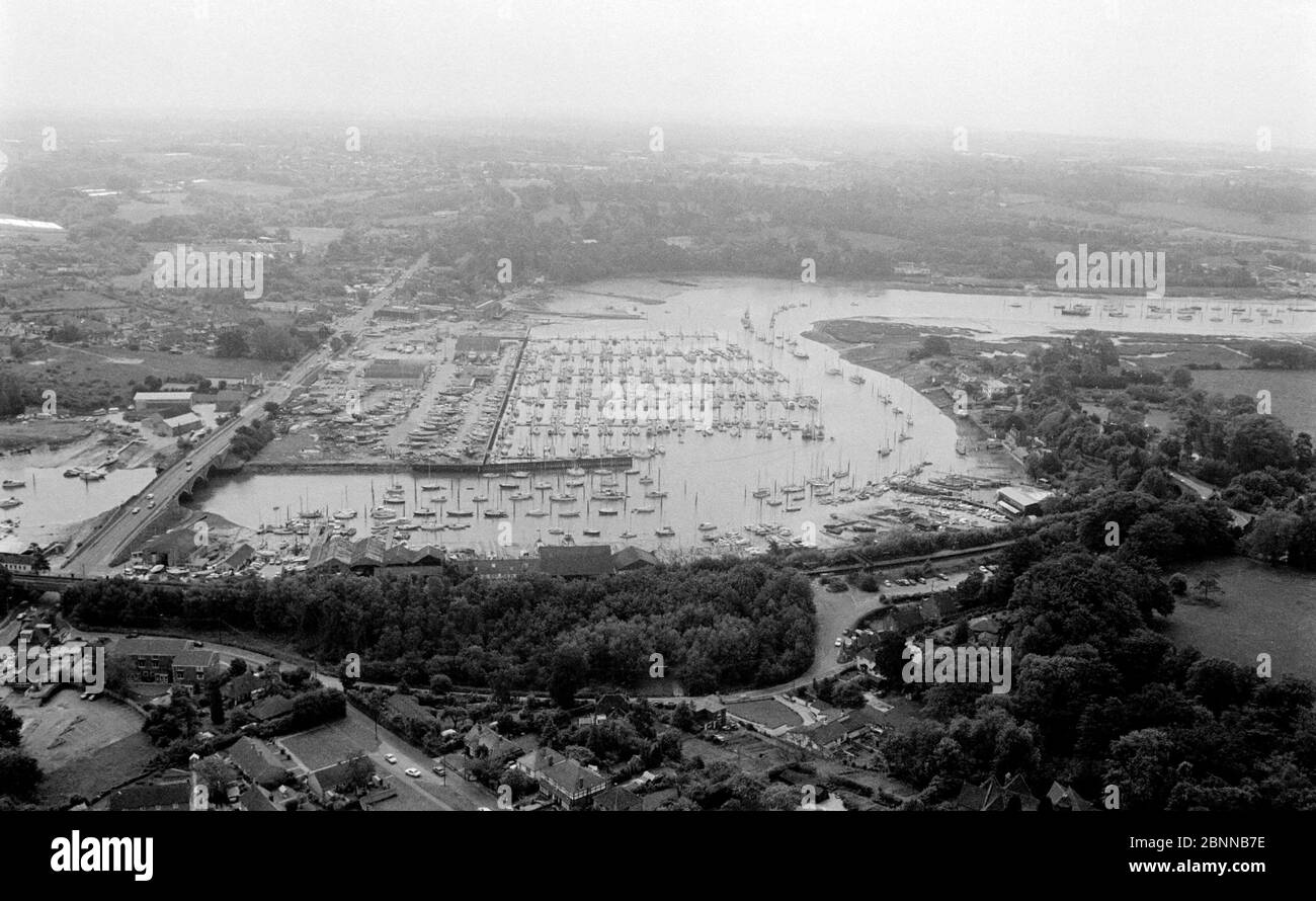 AJAXNETPHOTO. 1979. BURSLEDON, ENGLAND. - YACHTING MECCA - AERIAL VIEW OF THE FAMOUS HAMBLE RIVER LOOKING EAST FROM BURSLEDON TOWARD SWANWICK MARINA (CENTRE). DEACONS BOATYARD AND BURSLEDON POOL ARE VISIBLE FOREGROUND IN FRONT OF RAILWAY LINE; A27 ROAD BRIDGE IS AT LEFT.PHOTO:JONATHAN EASTLAND/AJAX REF:1979 14066 Stock Photo