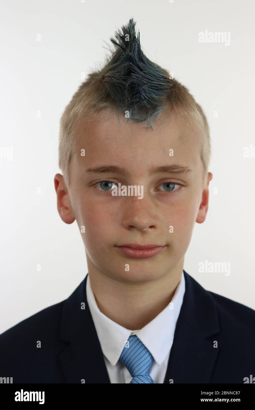 Portrait of a boy with a blue mohawk wearing a business suit Stock Photo