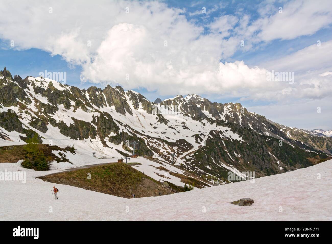 France, Chamonix, late May, top station of Plan Praz telecabine (gondola), ski run, spring snow melt, hikers Stock Photo