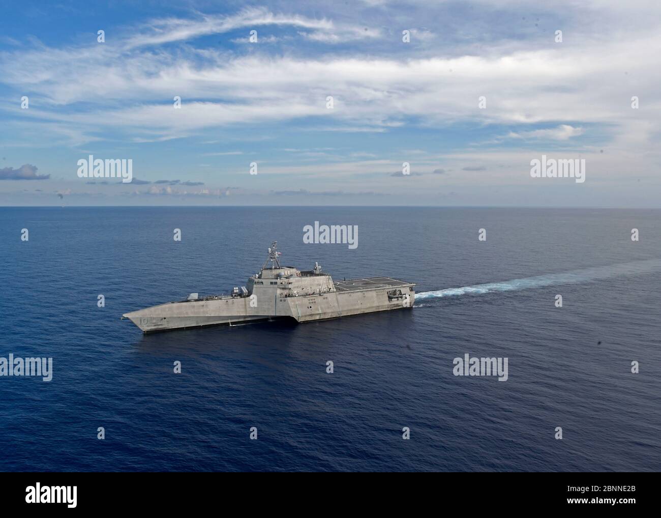 The U.S. Navy Independence-variant littoral combat ship USS Gabrielle Giffords patrols near the Panamanian flagged drill ship, West Capella which has been harassed by Chinese forces for drilling in disputed waters May 13, 2020 in the South China Sea. Stock Photo