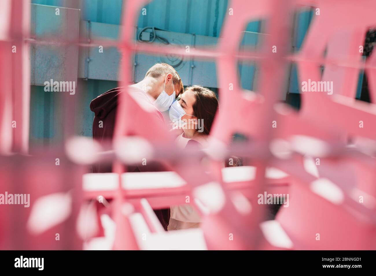 Loving couple kisses in medical masks in city Stock Photo - Alamy