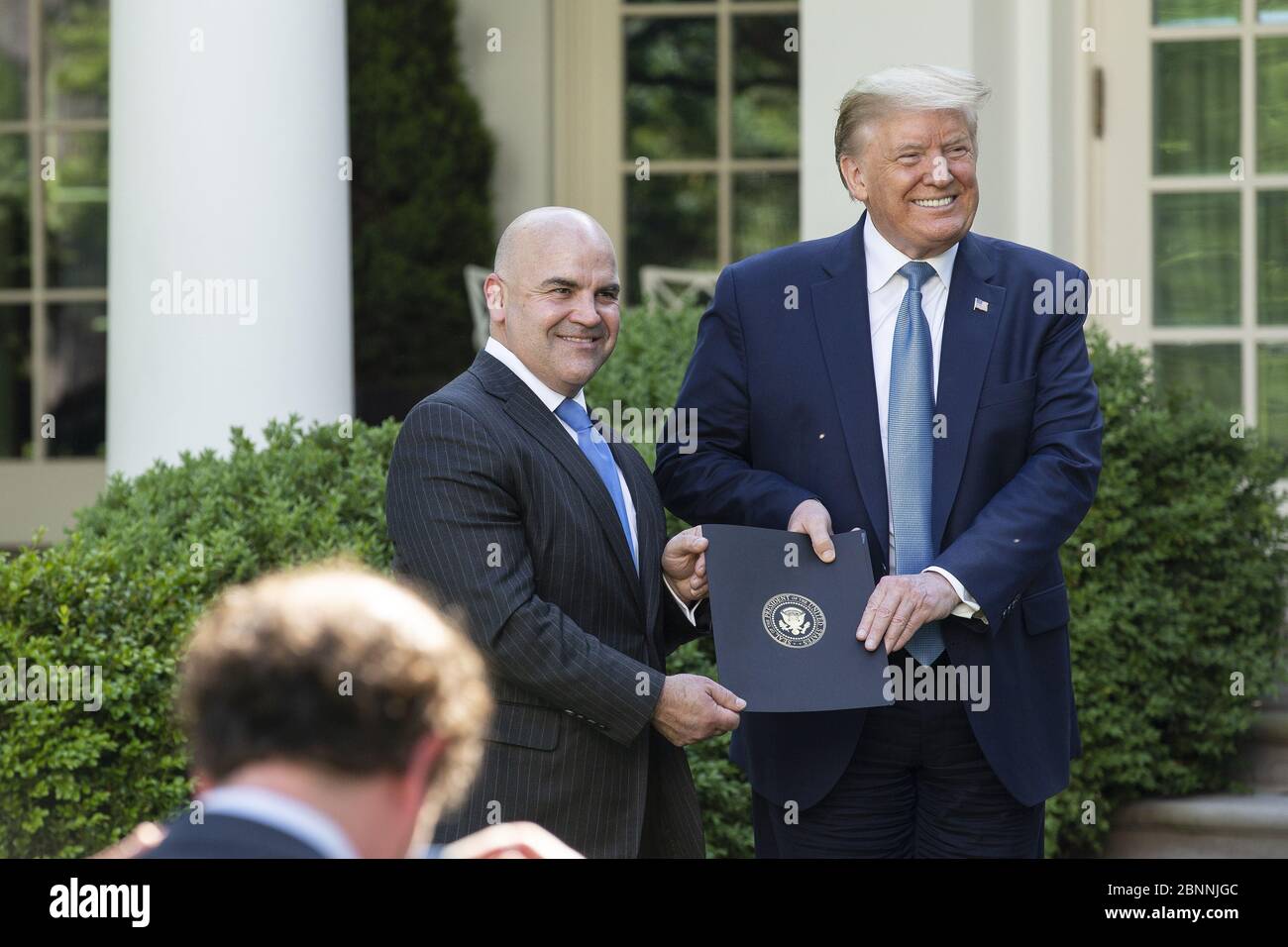 Washington, United States. 15th May, 2020. President Donald J. Trump poses for a photo with landlord Clay Young as he presents him with a letter of recognition during a Presidential Recognition Ceremony on Hard Work, Heroism, and Hope in the Rose Garden of the White House in Washington, DC, U.S. on Friday, May 15, 2020. Photo by Stefani Reynolds/UPI Credit: UPI/Alamy Live News Stock Photo