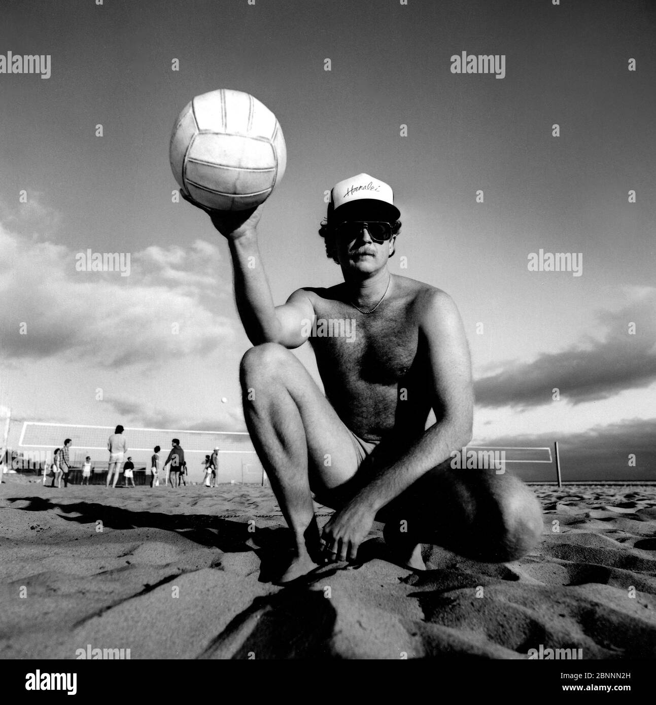 Classic black and white environmental portrait of beach volleyball player at Will Rogers beach in Santa Monica, CA Stock Photo