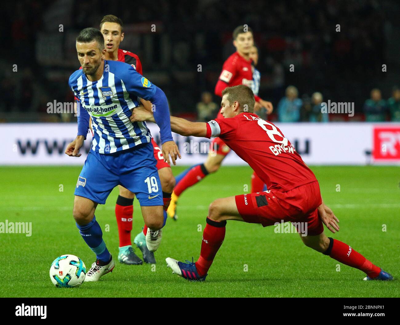 Berlin, Germany - September 20, 2017: Vedad Ibisevic of Hertha BSC Berlin (L) fights for a ball with Lars Bender of Bayer 04 Leverkusen during their German Bundesliga game at Olympiastadion Berlin Stock Photo