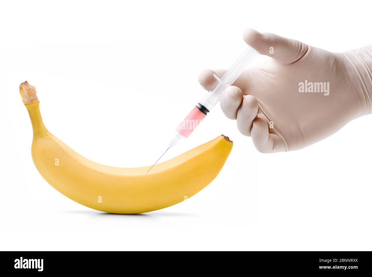 Injecting a liquid into a banana Stock Photo