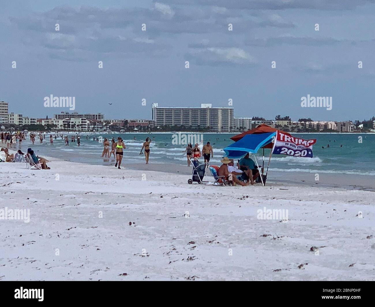 Trump supporters display a 2020 flag at the beach as Sarasota County lifted its restrictions at popular beaches such as Siesta Key. Stock Photo
