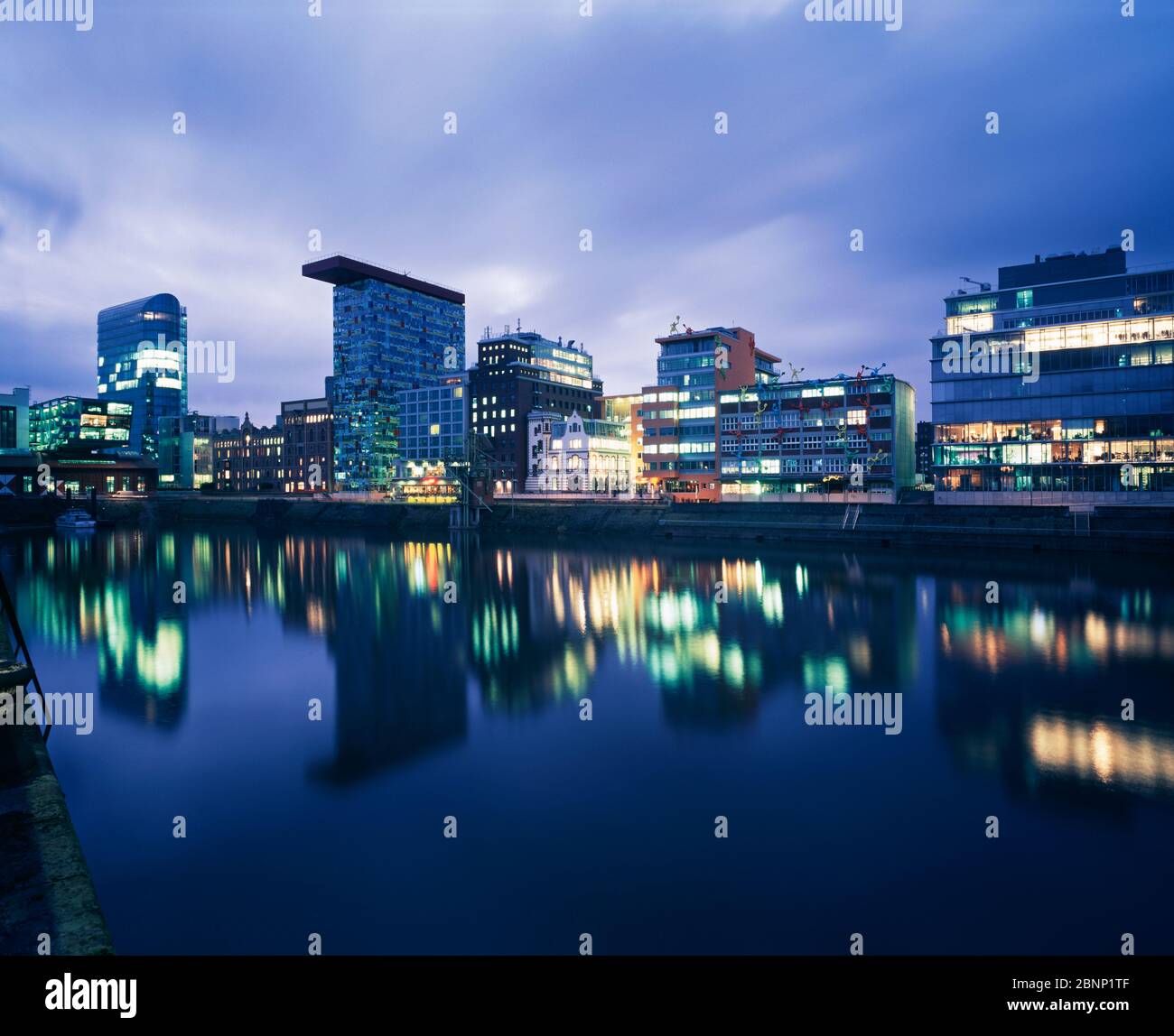 Modern buildings reflecting into water at the Media Harbour.  Düsseldorf, Germany Stock Photo