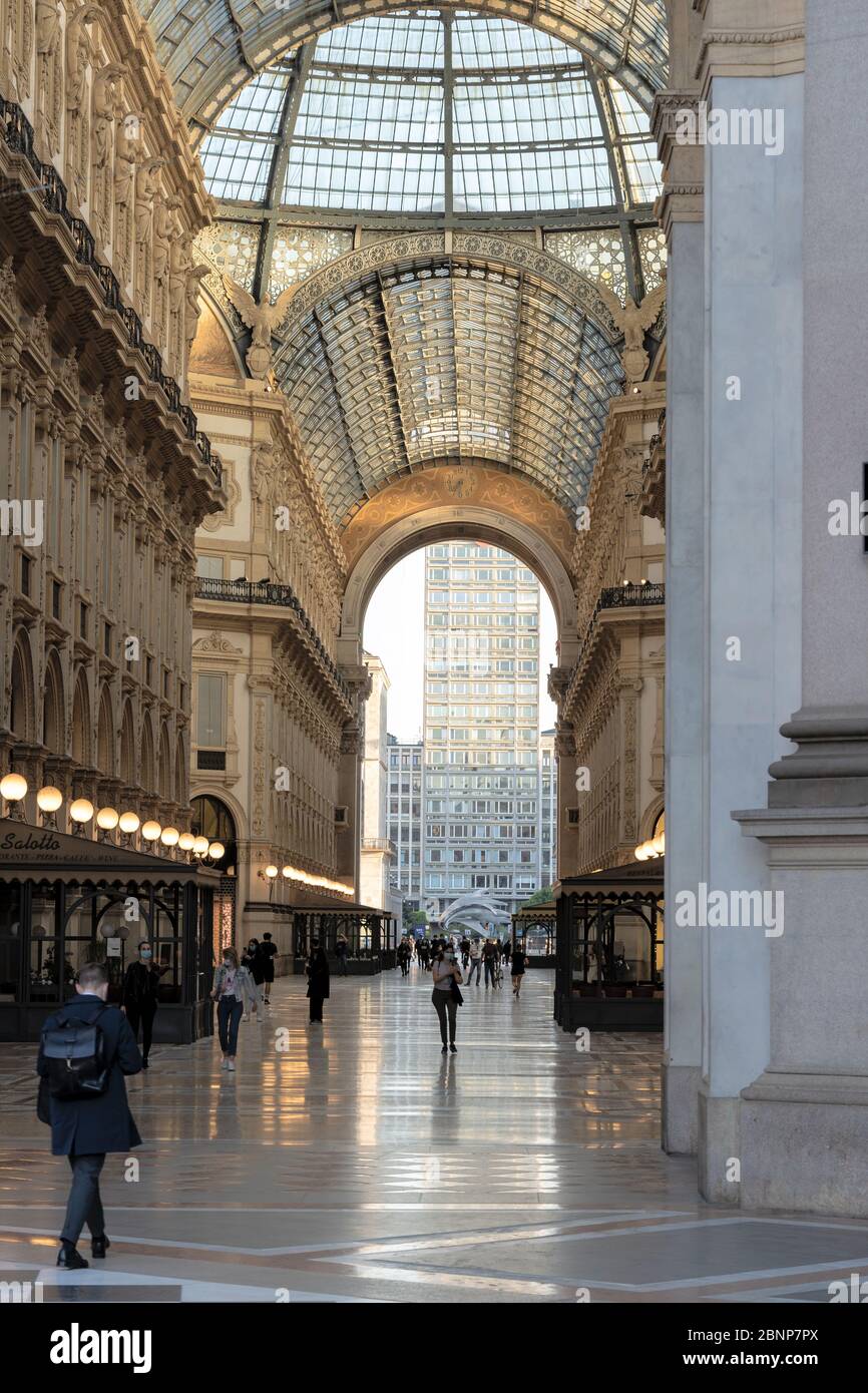Milan, Italy - May 4, 2020: Italy enters second phase of coronavirus COVID-19 lockdown. People go to work wearing face mask and maintain social distan Stock Photo