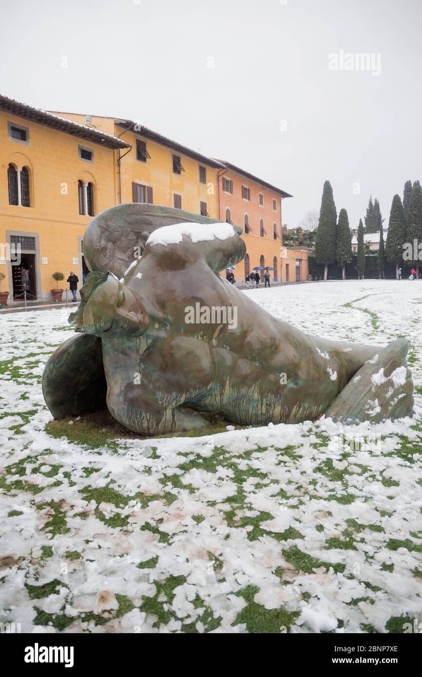 A fallen angel sculpture under a snowy weather, Pisa, Central Italy, Europe Stock Photo