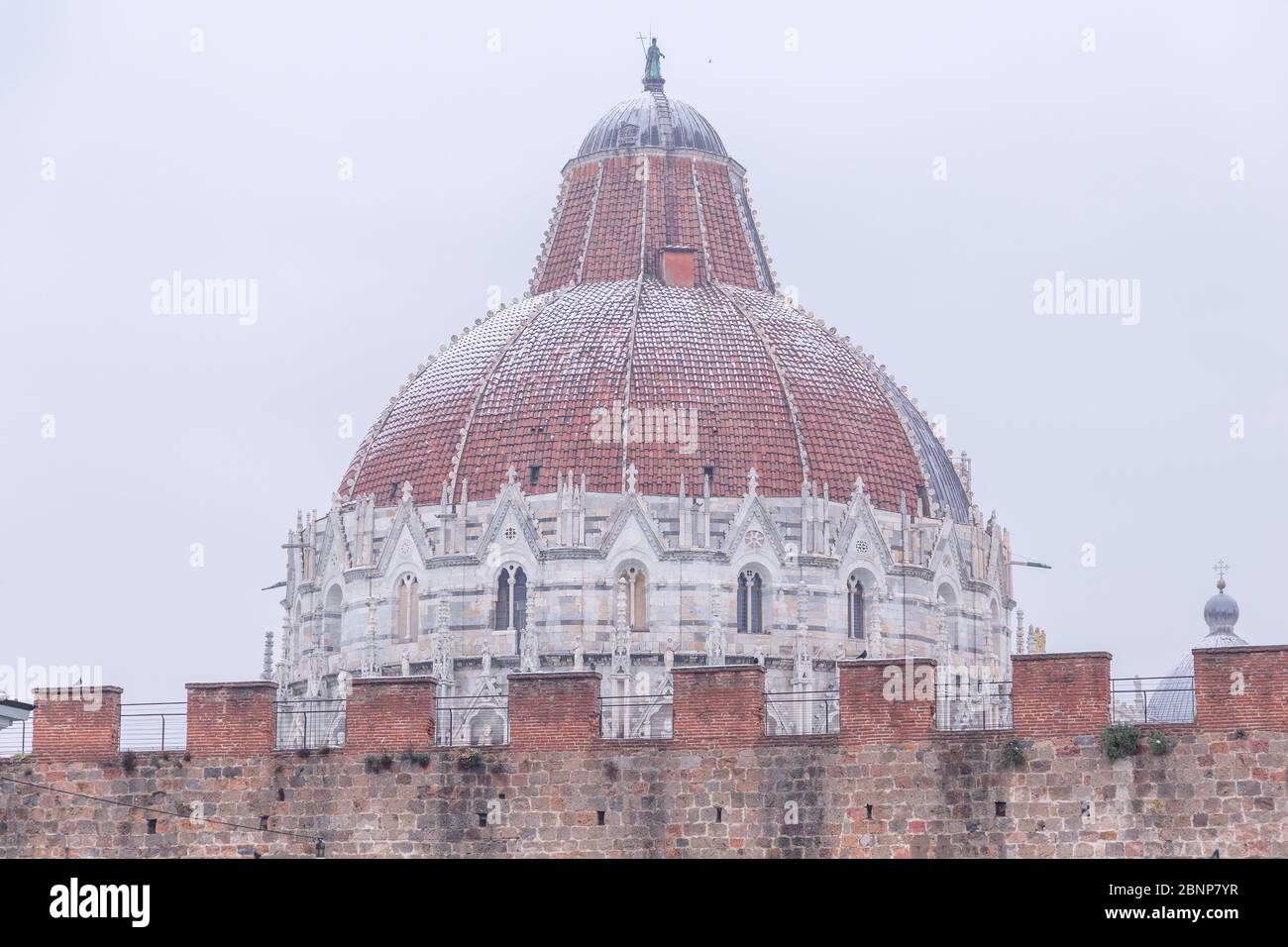 Baptistery top and fortified walls in a snowy day, Campo dei Miracoli, Pisa, Tuscany, Italy, Europe Stock Photo