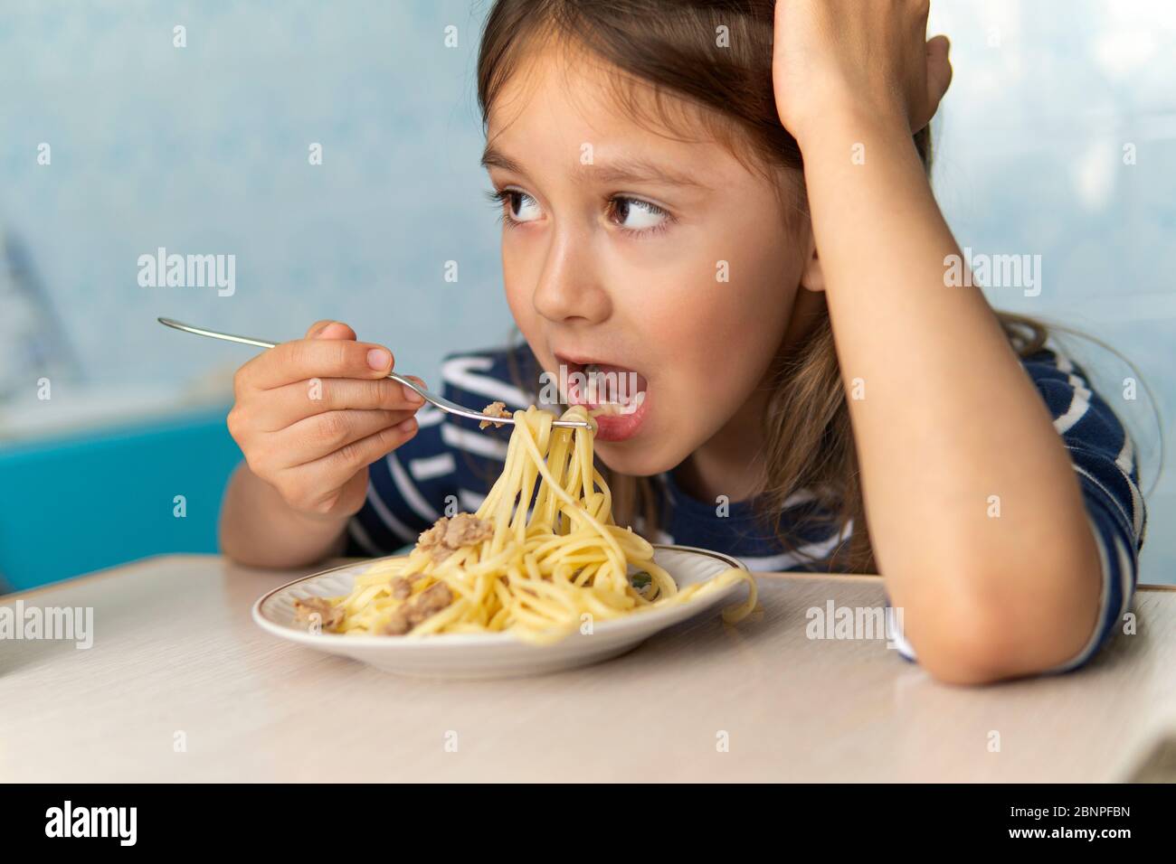 Kids eat pasta. Healthy lunch for children. Toddler kid eating