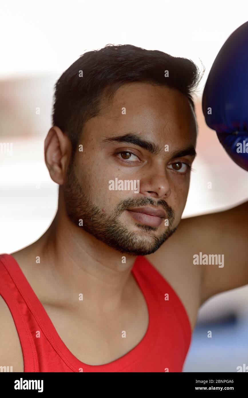 Face of young handsome bearded Indian man as boxer training at the gym  Stock Photo - Alamy