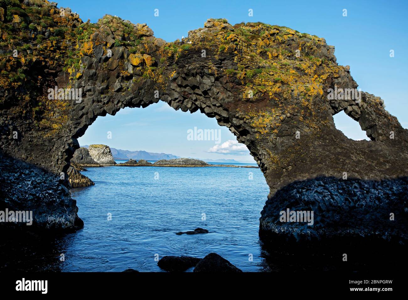Basalt cliffs on the coast at Arnarstapi. View of the Snaefellsnes ...