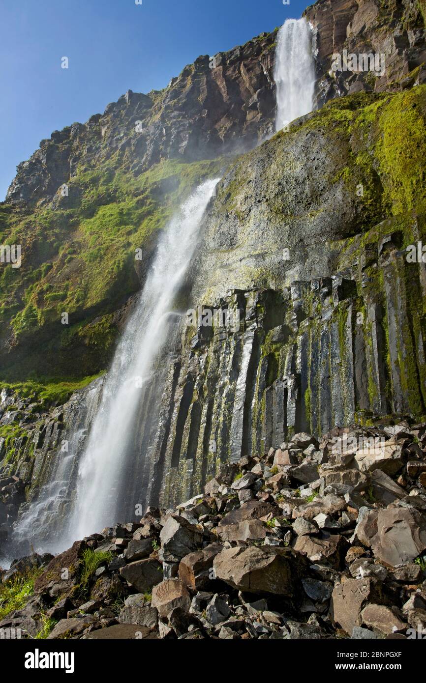 The 80m high Bjarnafoss near Landakotsgil on the south coast of the Snaefellsnes peninsula falls over basalt columns. Stock Photo