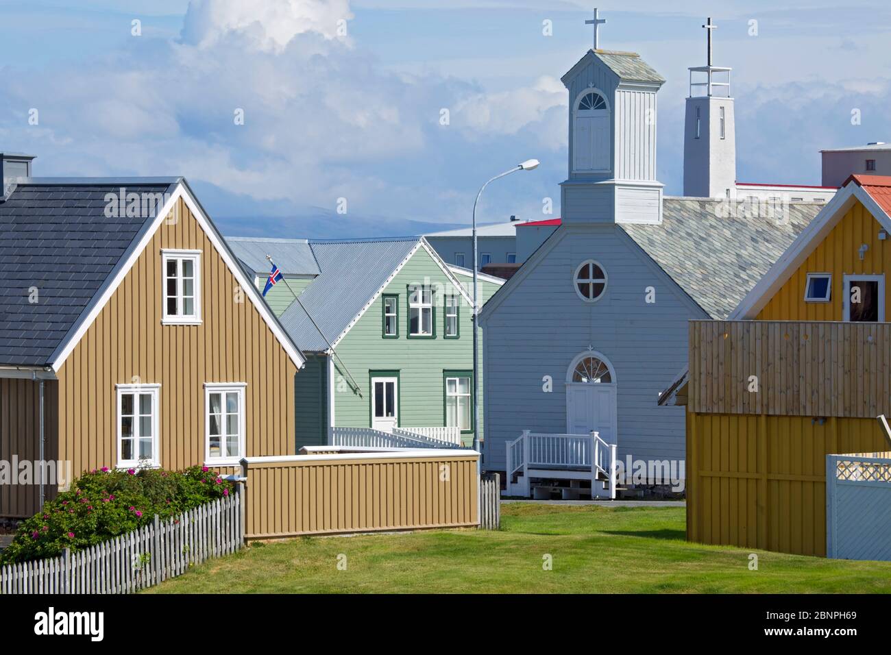 Old part of Stykkisholmur. on the left the 'Fruarhusid', a Danish trading house from 1858 and on the right the old church from 1878. Behind it is the tower of the Franciscan Hospital. Stock Photo