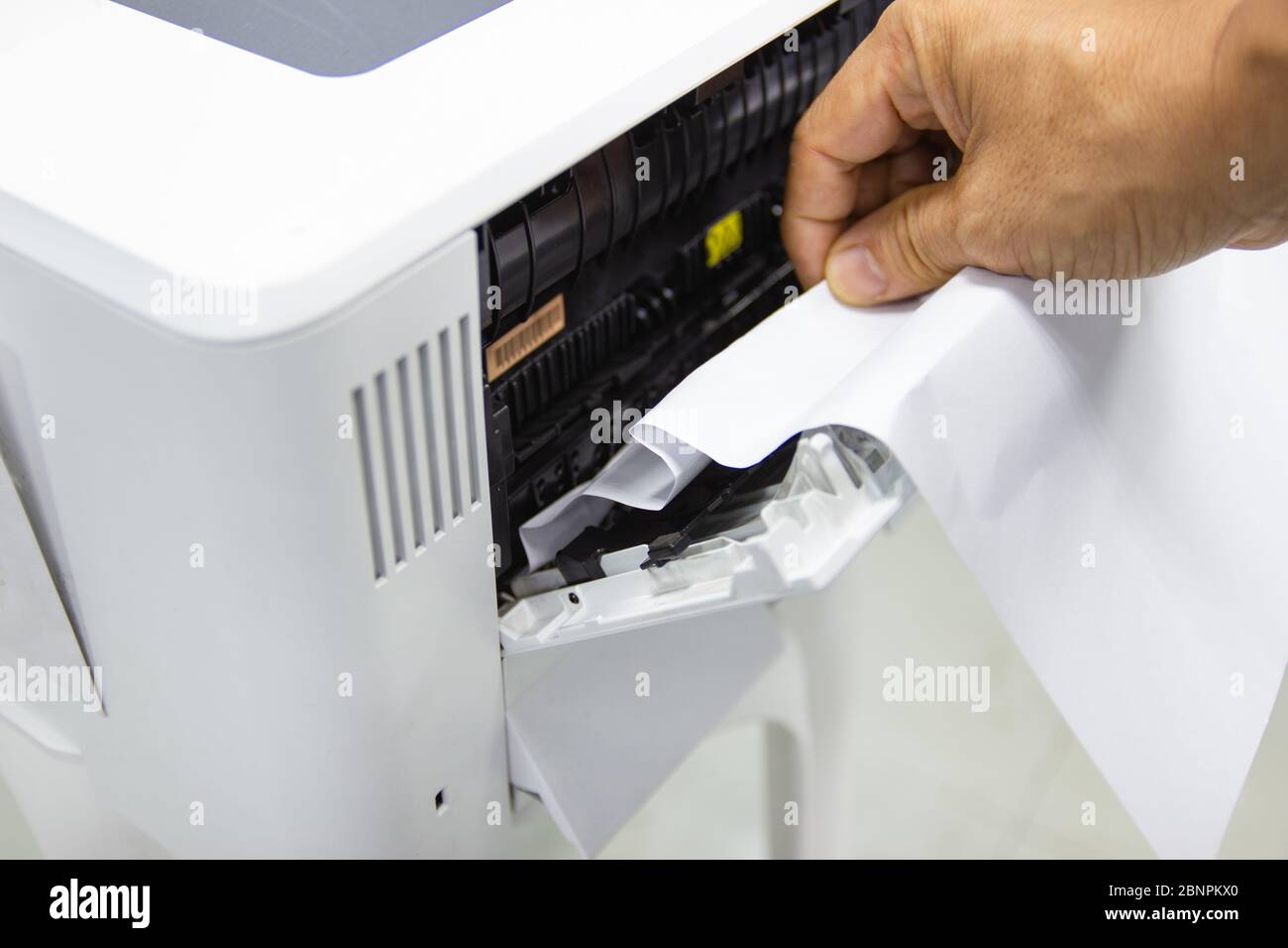Technicians Removing Paper Stuck, Paper Jam In Printer At Office Stock