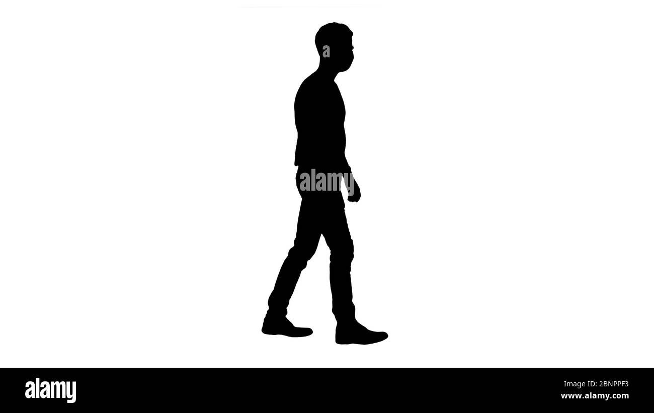 Silhouette Young handsome man walking with medical mask on. Stock Photo