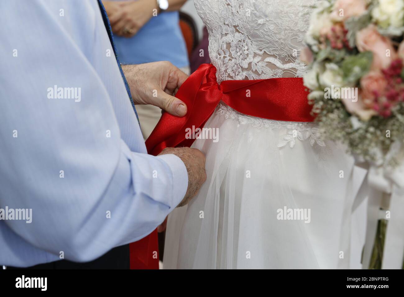 white dress with red ribbon