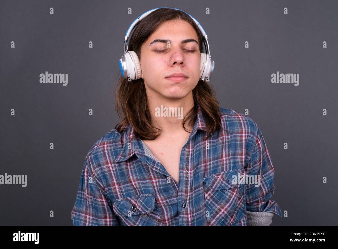 Young handsome hipster man with long hair Stock Photo