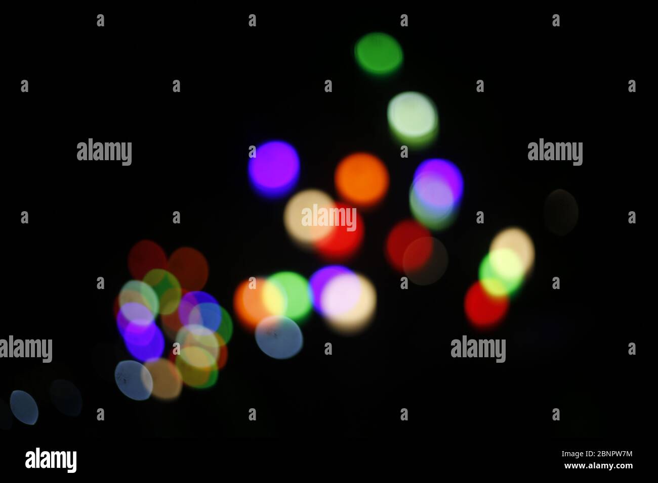 Colorful light bokeh moving on black background Stock Photo - Alamy