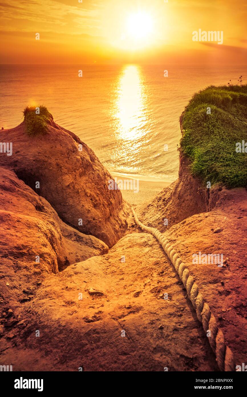 Rock cliff on the west coast of Denmark on the Atlantic Ocean at sunset Stock Photo