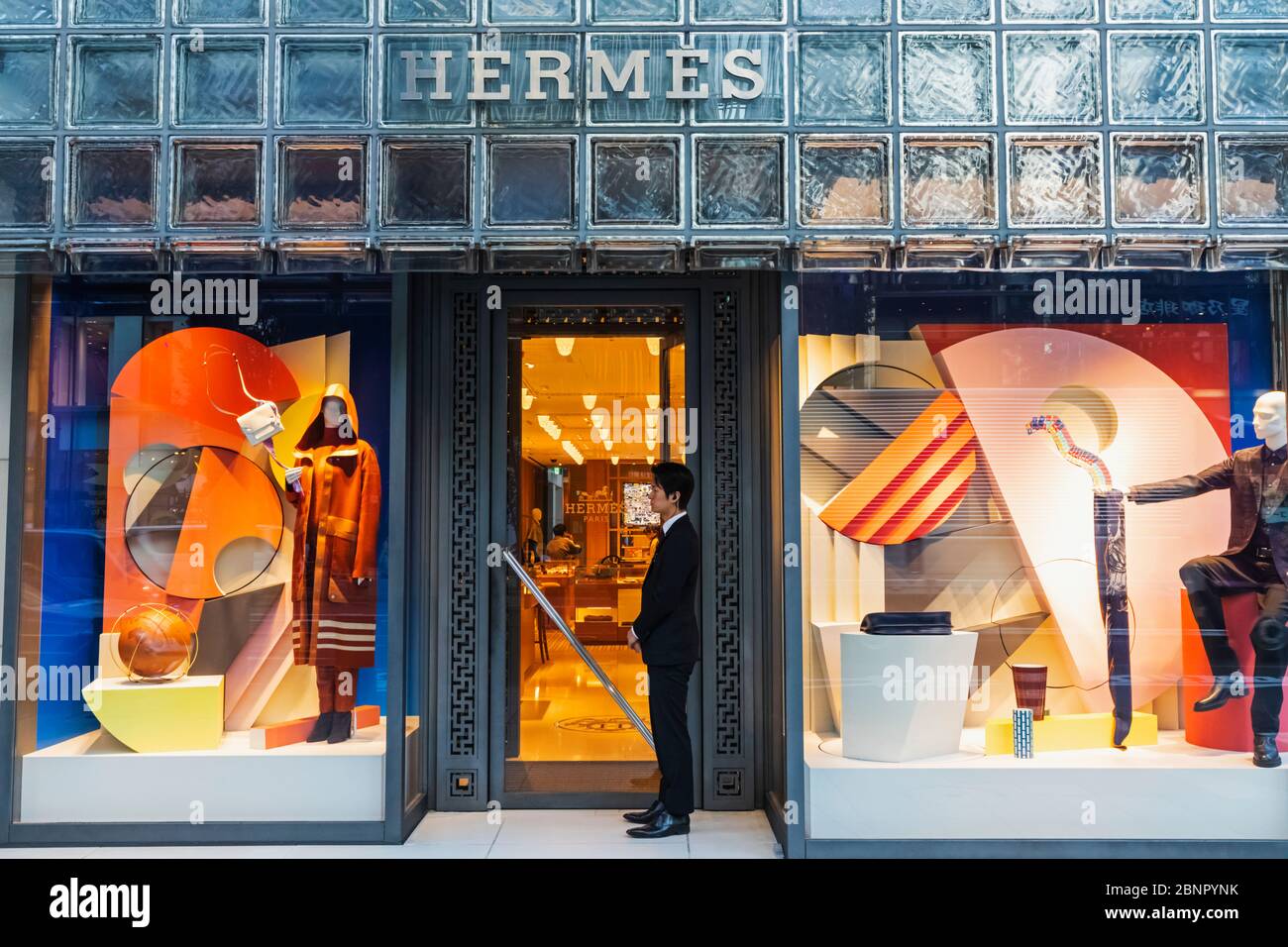 Japan, Honshu, Tokyo, Ginza, Hermes Store Window Display and Doorman Stock Photo