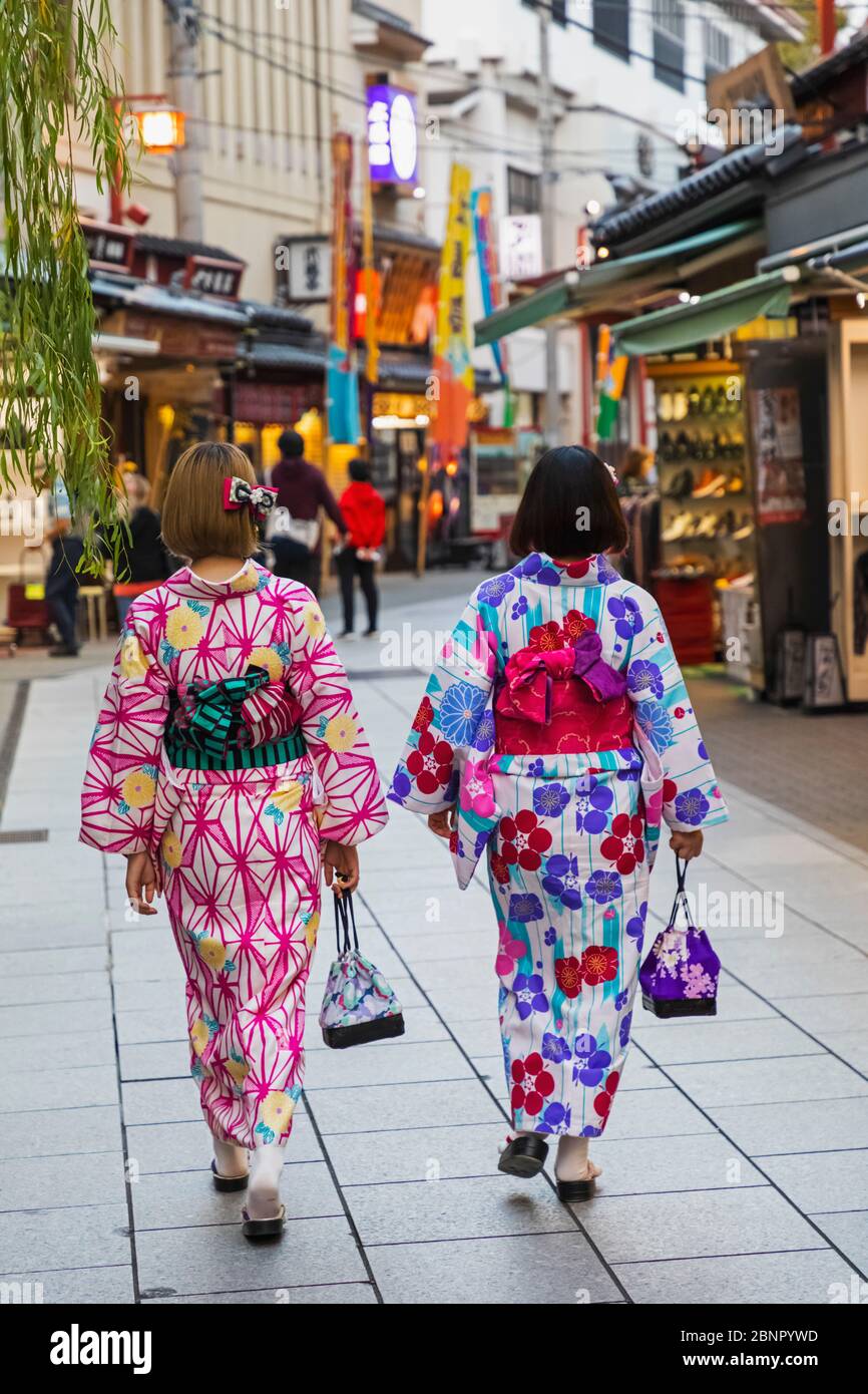 Japan, Honshu, Tokyo, Asakusa, Two Women in Kimono Walking in the Street Stock Photo