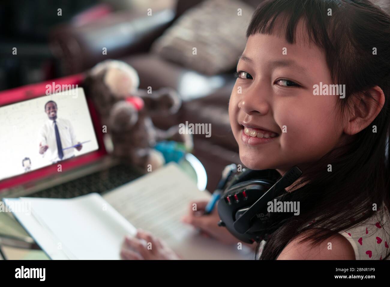 Little child girl  learning on laptop at home,Social distance during quarantine, Online education concept Stock Photo