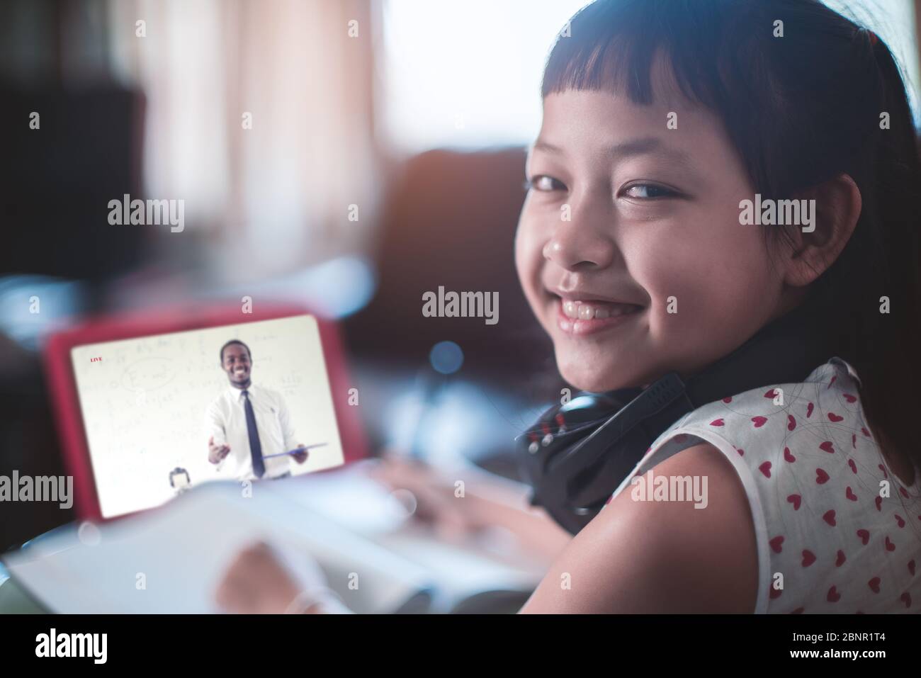 Little child girl learning on laptop at home,Social distance during quarantine, Online education concept Stock Photo