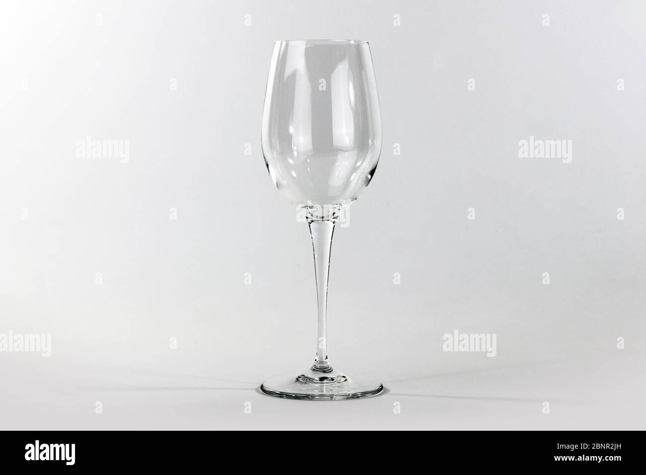 Glass flute in empty glass on white background Stock Photo