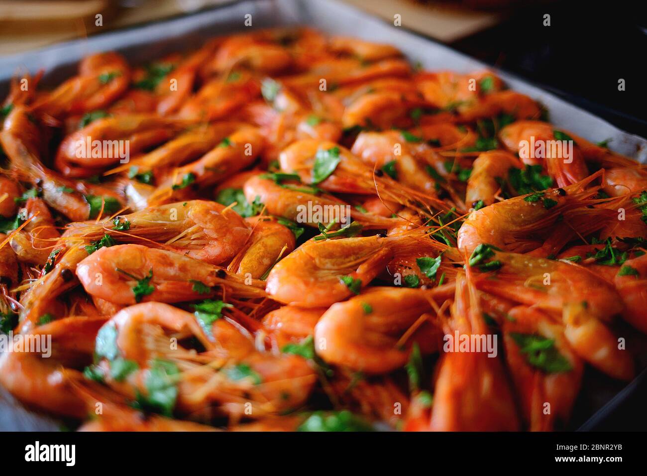 Fresh boiled prawns with coriander. A delicious dish of seafood. Stock Photo